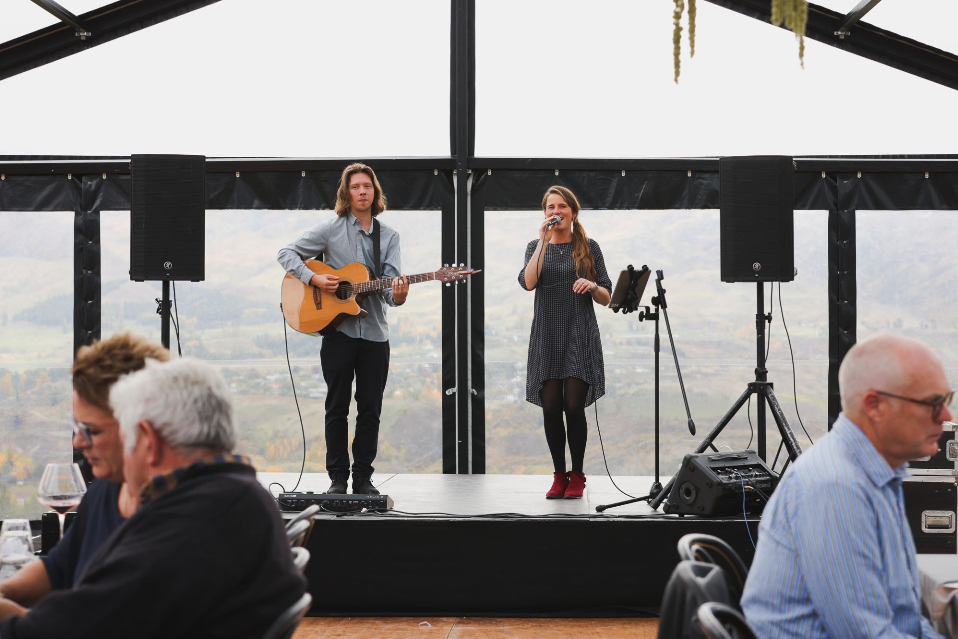 Elle and Alex performing at a corporate event