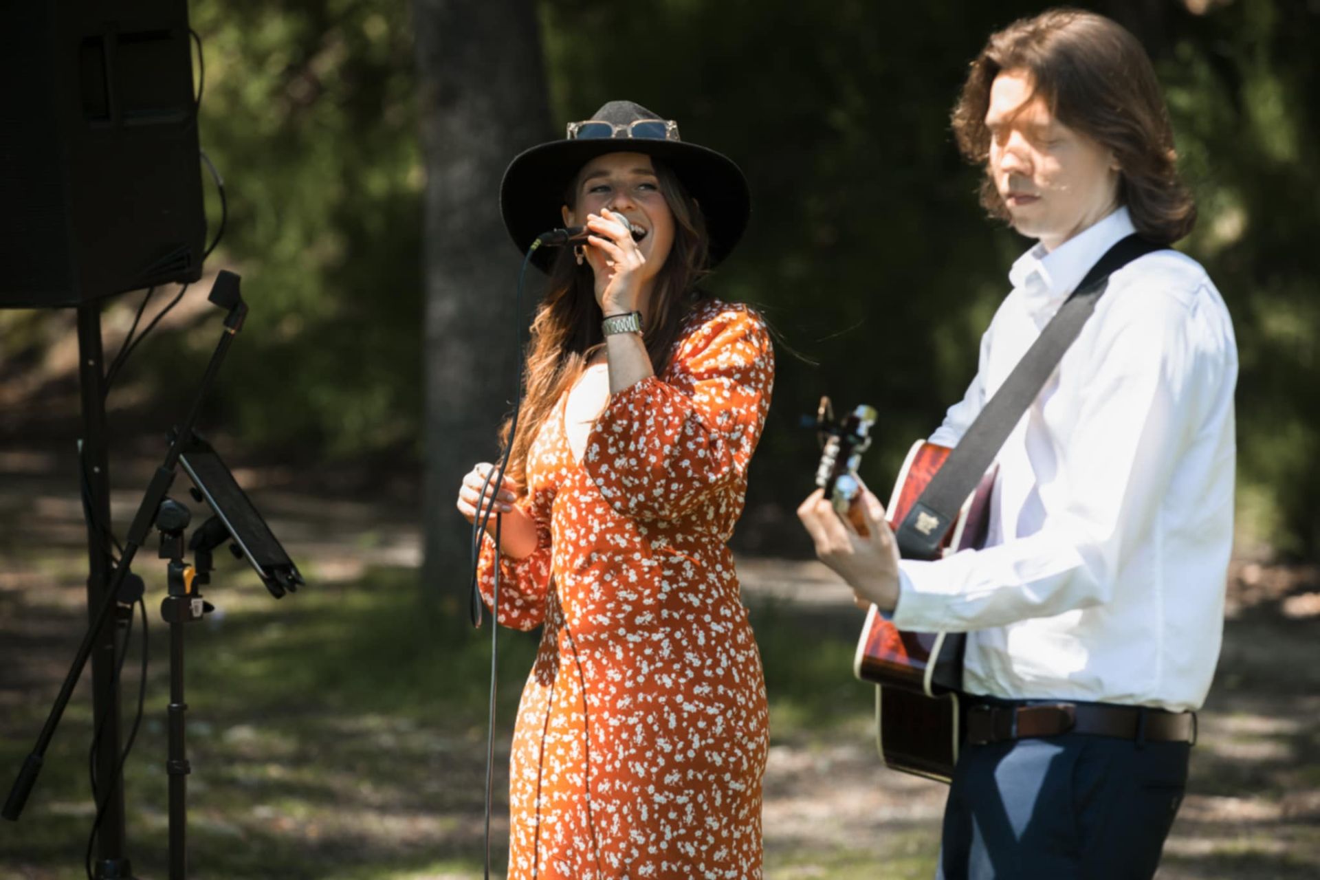 Elle and Alex performing outdoors at a party