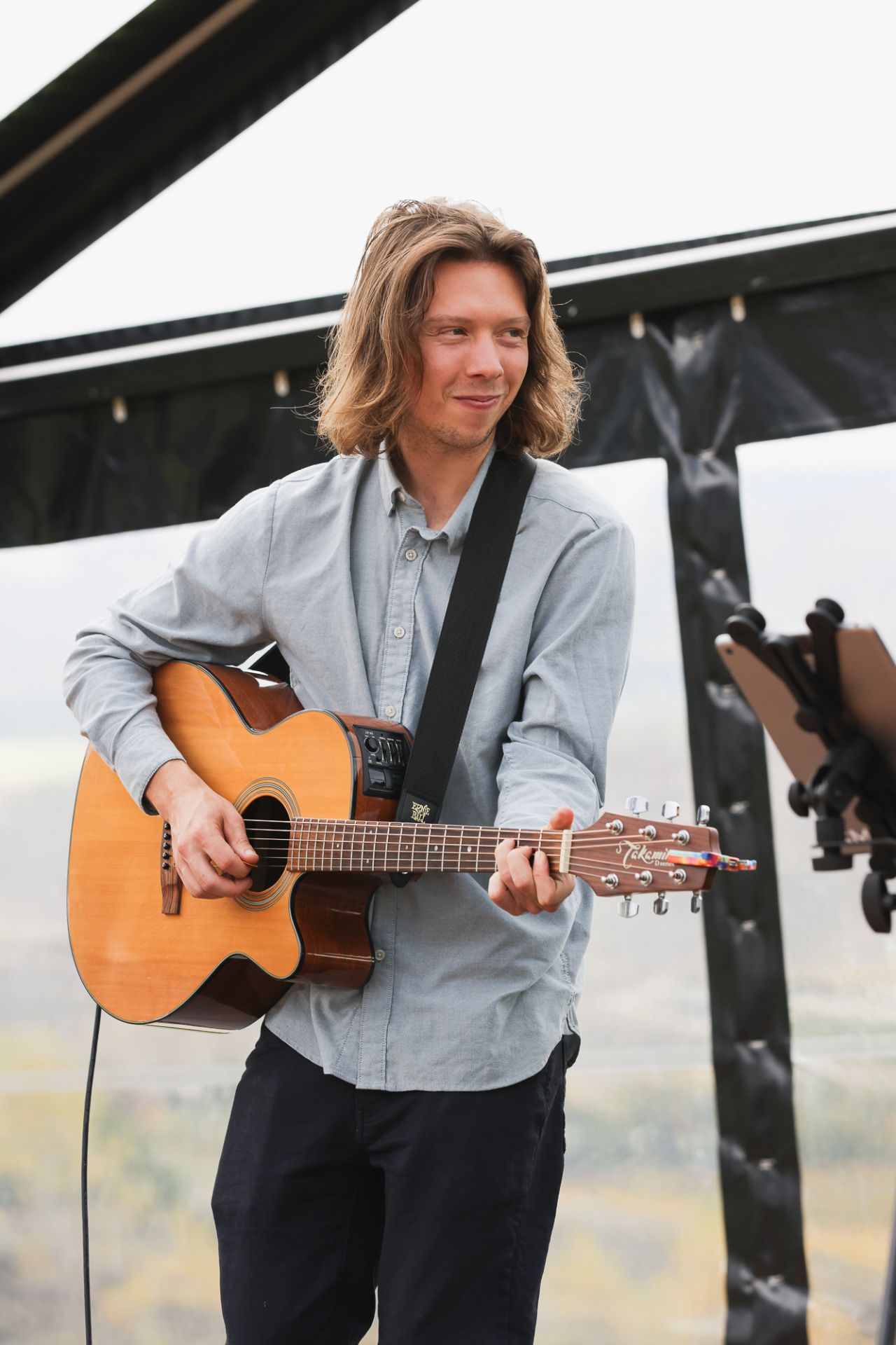 Alex playing acoustic guitar