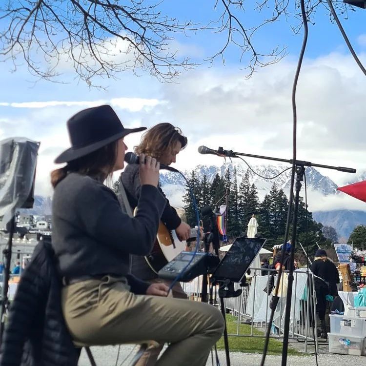 Elle singing at an outdoor event