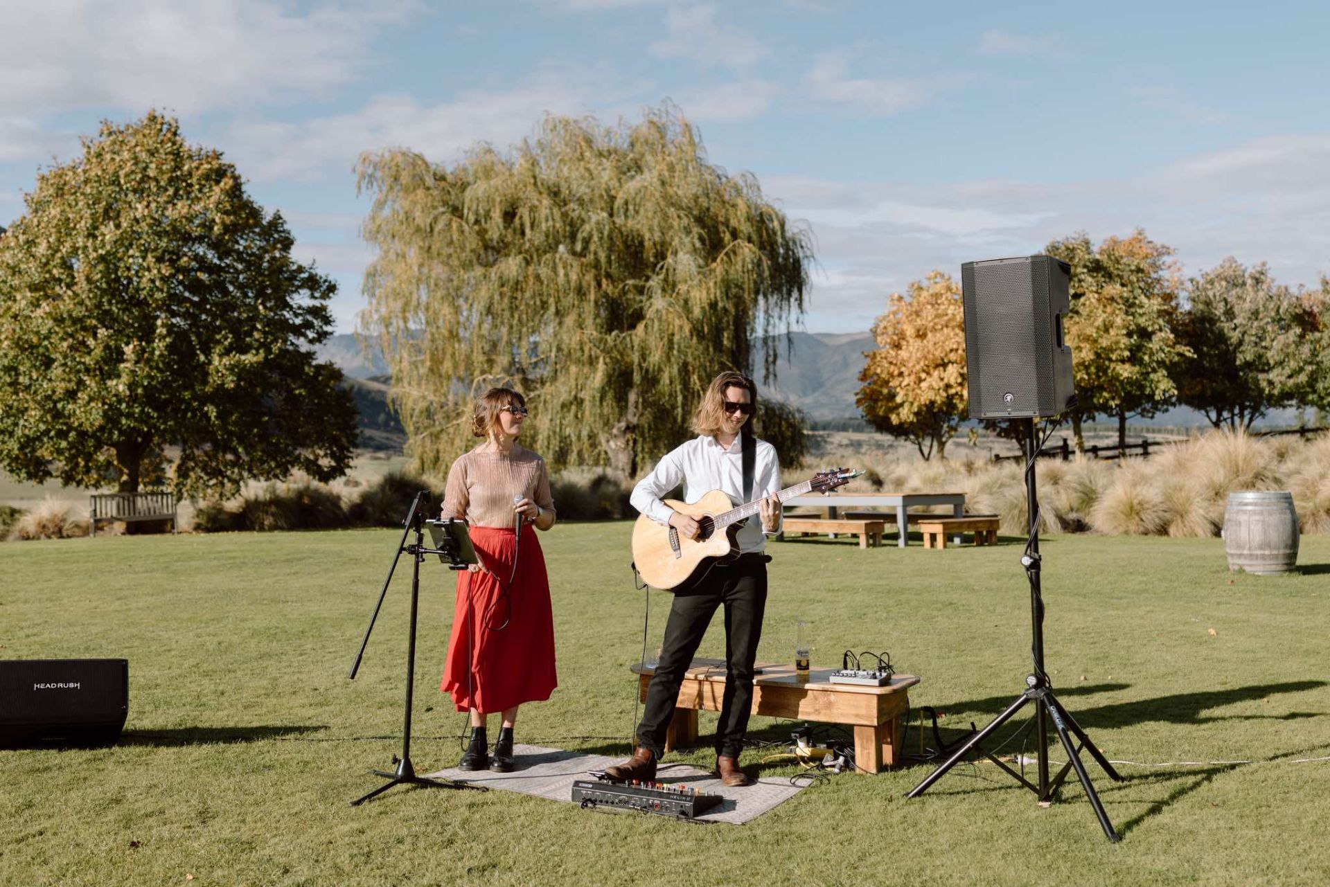 Elle and Alex playing at an outdoor wedding