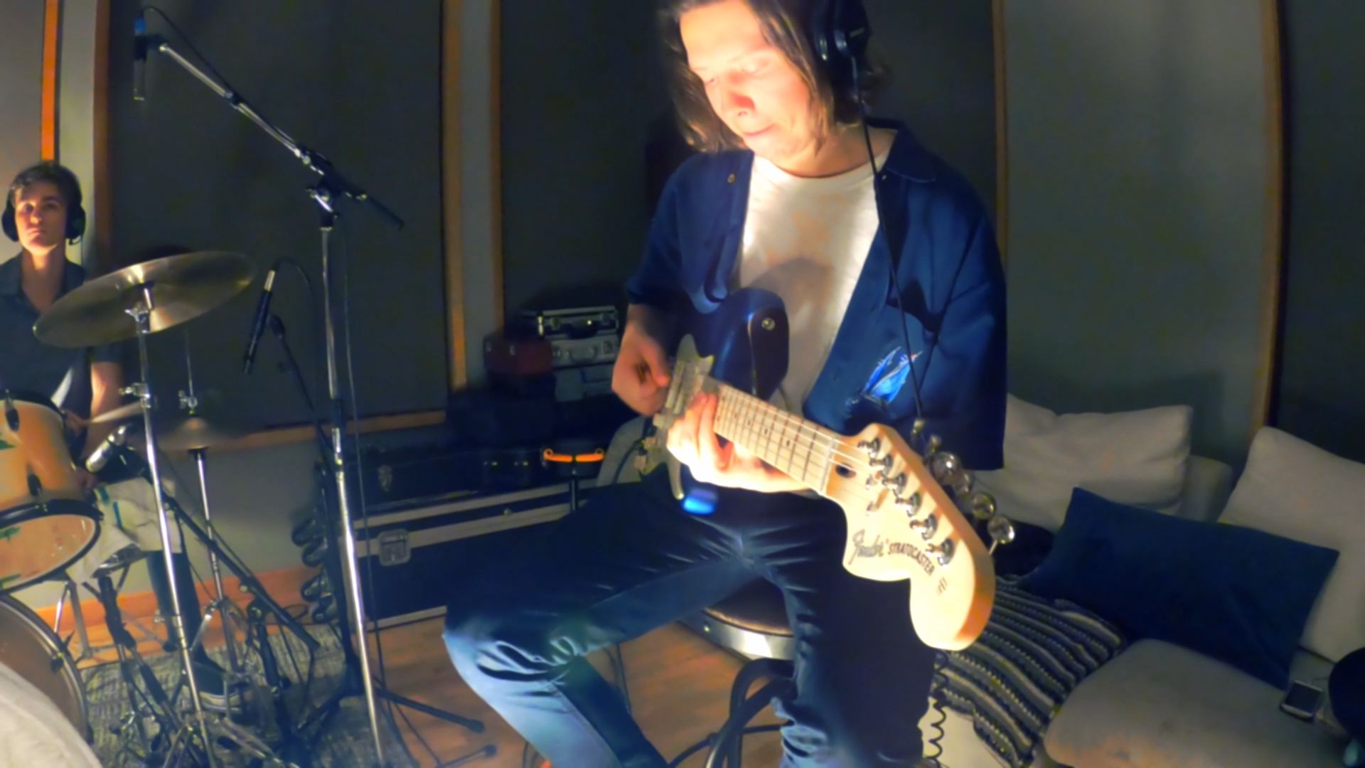 Alex playing electric guitar in the studio